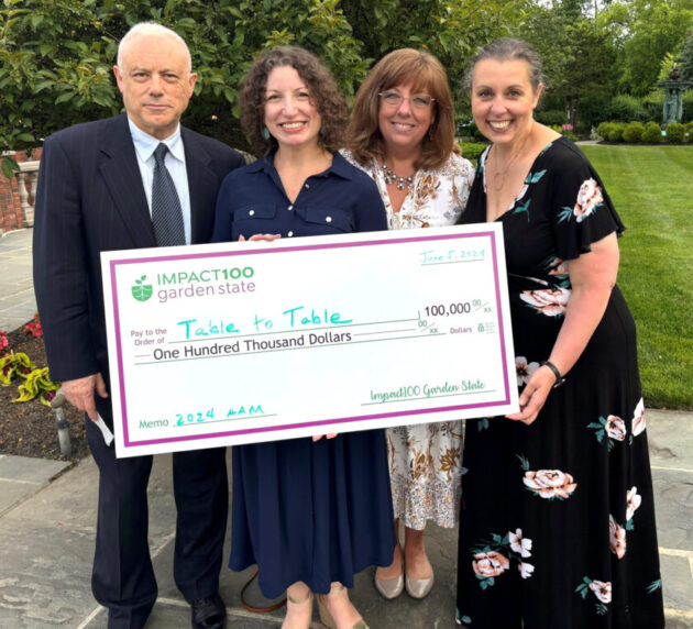 Table to Table staffers received a ceremonial check for $100,000 for a grant from Impact100 Garden State.