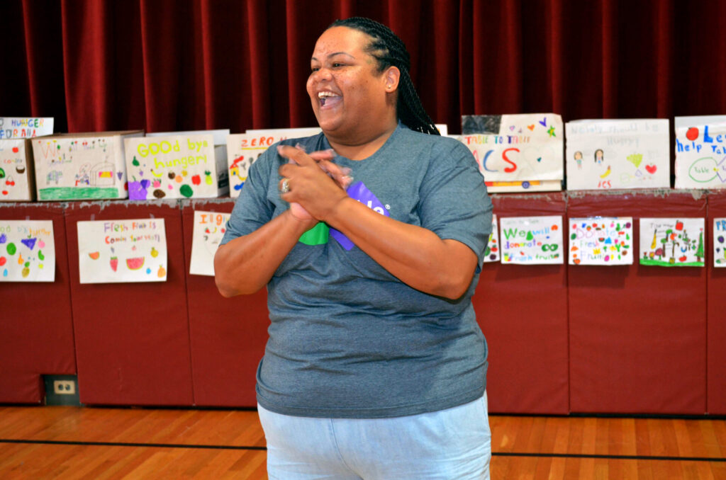 Table to Table's Volunteer Coordinator Stephanie Conley-Webb speaks to students at Anna C. Scott Elementary School in Leonia. Students from Anna C. Scott Elementary School in Leonia donated hundreds of pounds of fresh fruits and vegetables to Table to Table recently